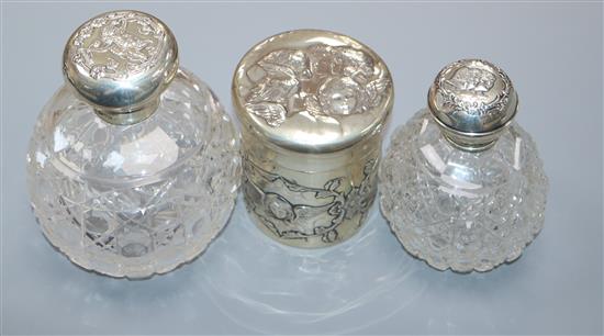 A late Victorian silver Reynolds Angels toilet box and cover, William Comyns, London, 1900 and two silver mounted scent bottles.